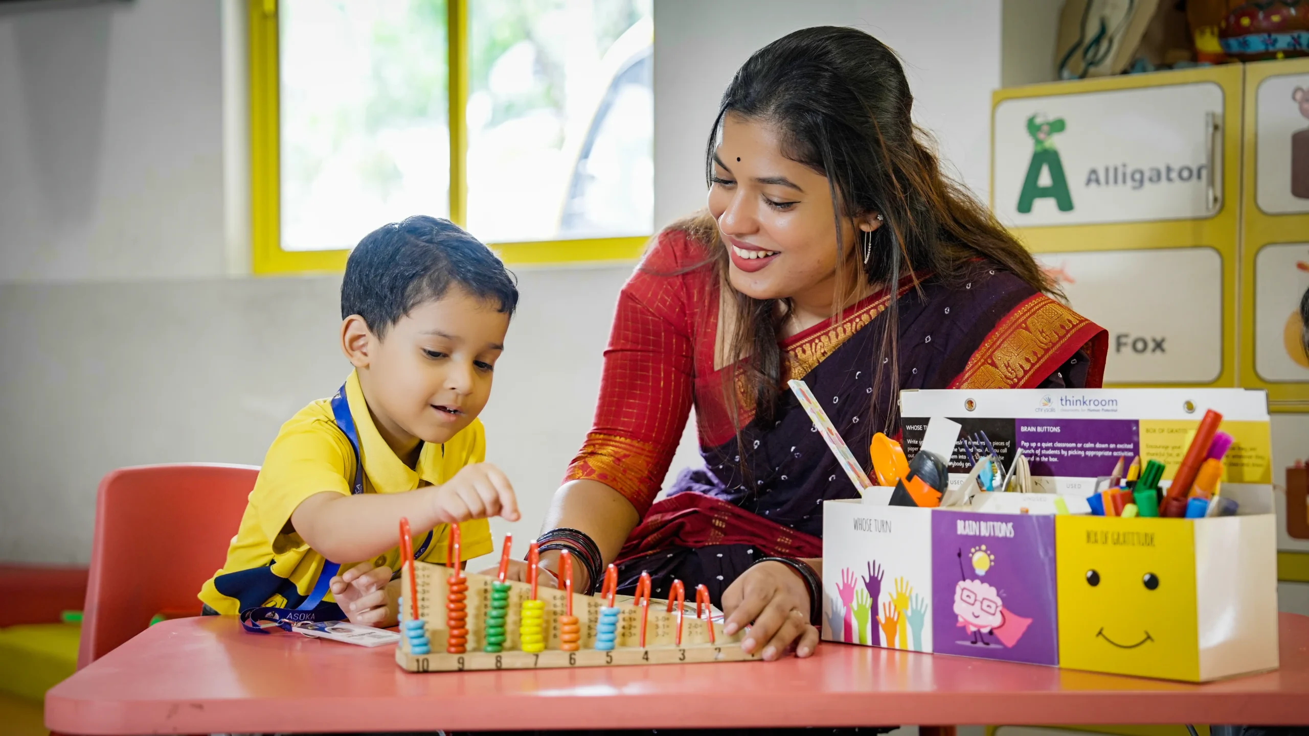 Teacher at Asoka Kindergarten teaching student